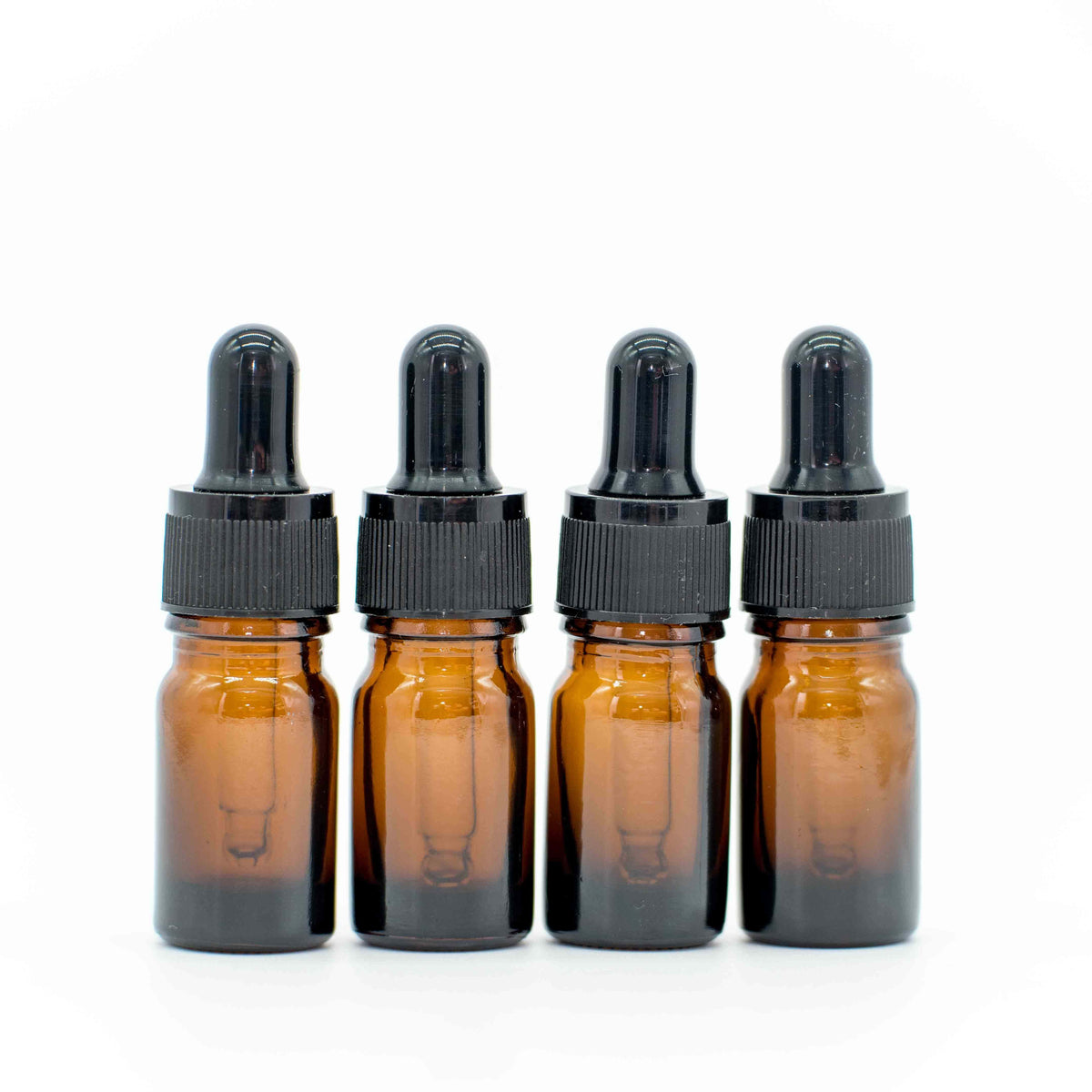 Four 5 ml brown glass pipette bottles with black droppers, arranged side by side on a white background.