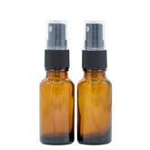 Two 20 ml brown glass spray bottles with black spray heads, designed for essential oils, displayed side by side.