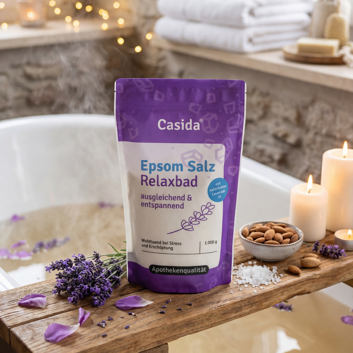 Epsom Salz Relaxbad by Casida in a purple bag, placed beside a bathtub with lavender and candles.