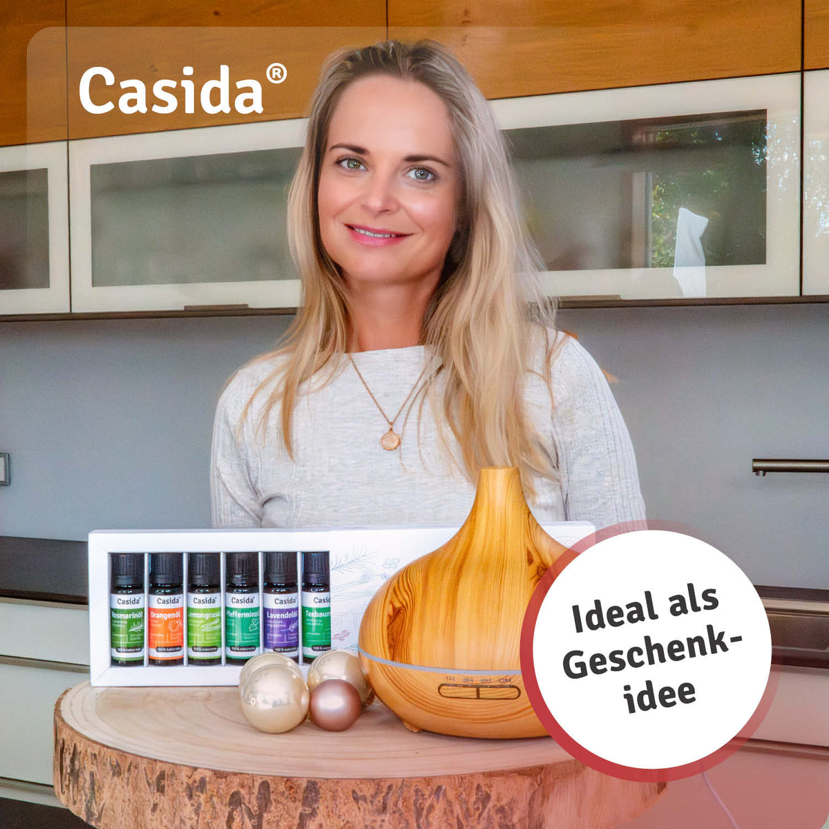 Eine Frau präsentiert Casida Aromadiffuser Holzdesign mit LED mit Top 6 Ätherischen Ölen