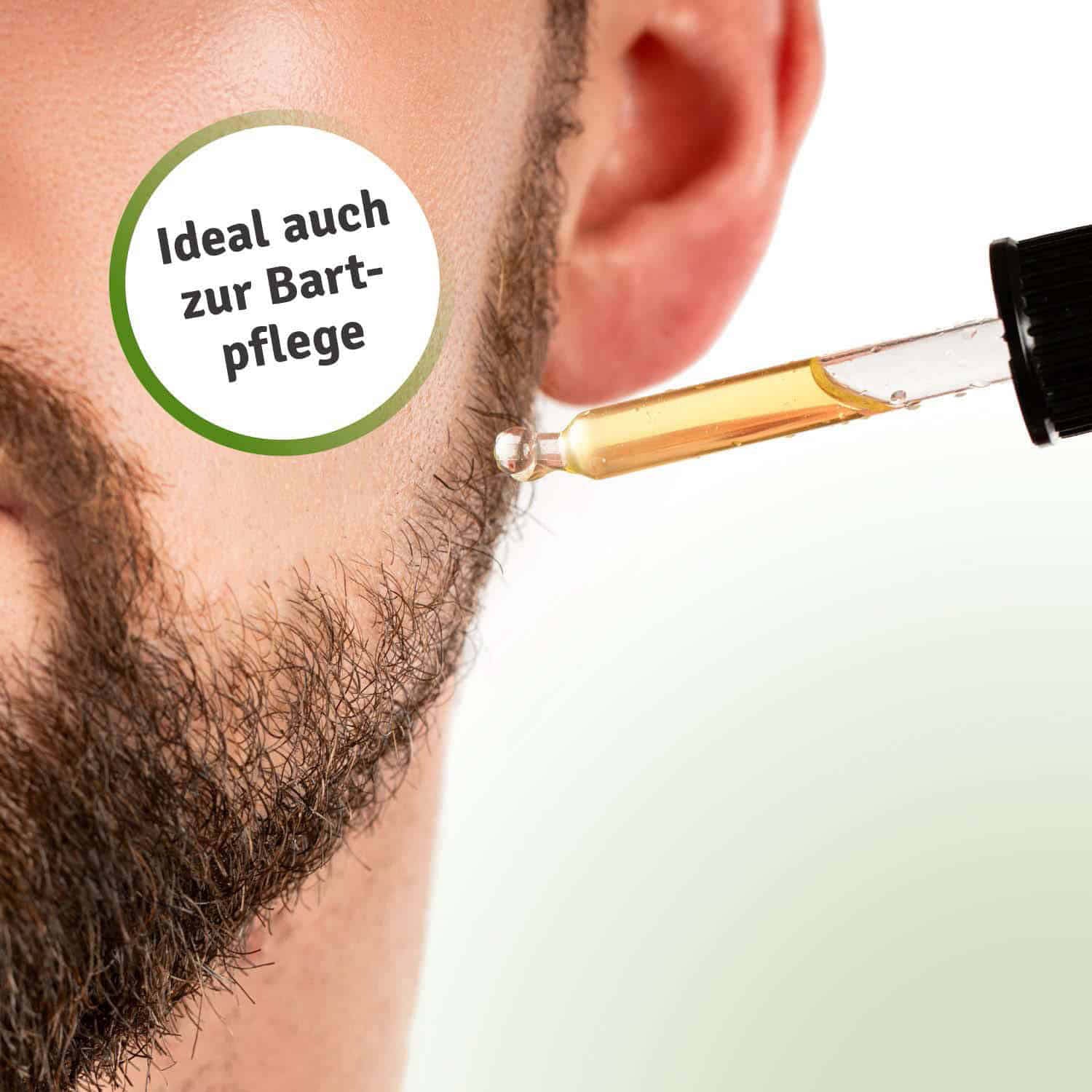 Casida Rosmarin Haarkur set with a dropper applying oil near a man's beard, showcasing hair care product use.