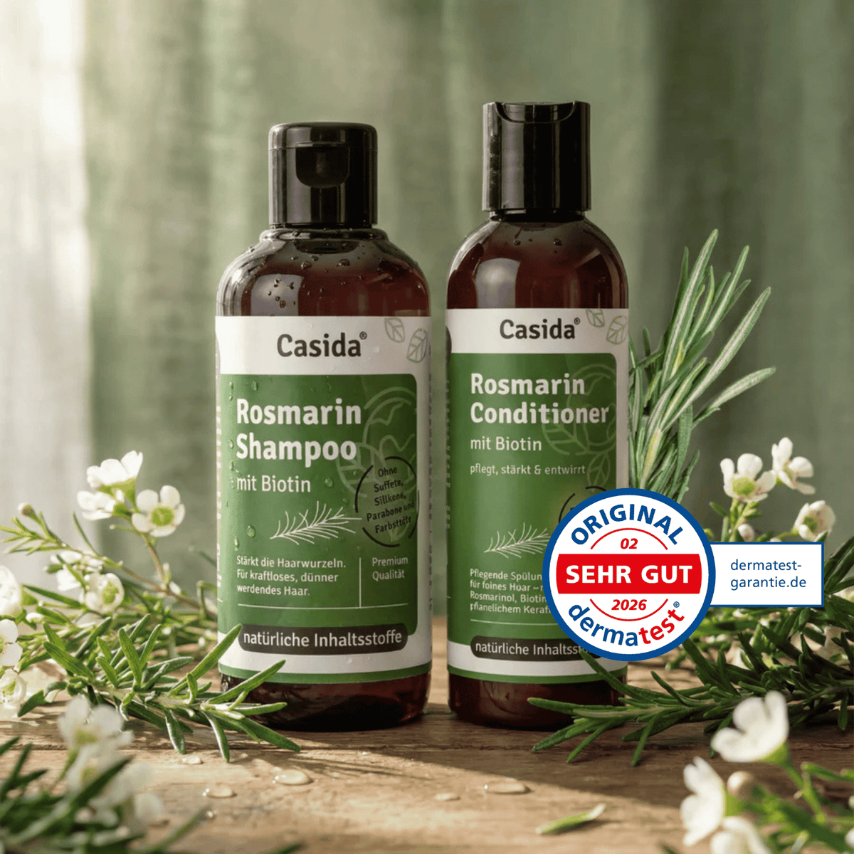 Rosmarin shampoo and conditioner set with biotin, featuring dark bottles and green labels, surrounded by rosemary and flow...