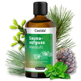 Saunaaufguss Waldluft oil bottle with green label, surrounded by pine branches and a pine cone.
