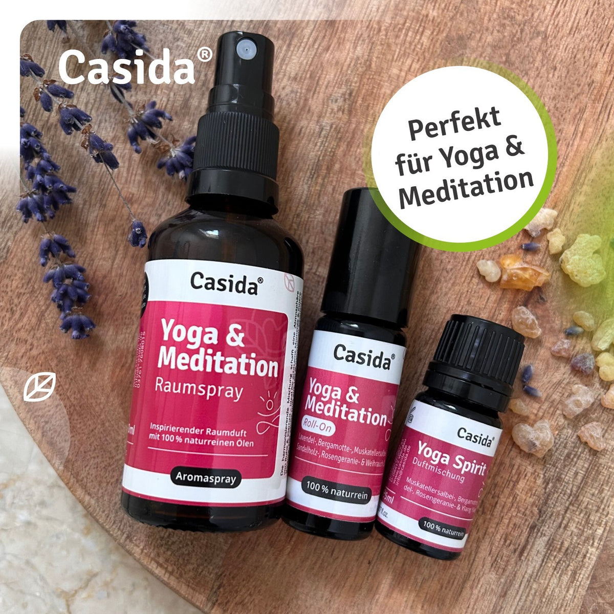 Yoga and meditation spray set with dark nozzle, lavender, colorful crystals, and essential oil roll-on.