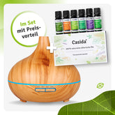 Aroma diffuser in wood design with six essential oil bottles and a product card displayed together.