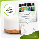 Aroma diffuser with remote control, 500 ml capacity, and six essential oils in a set, featuring a white and wood design.