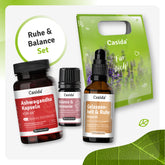 Ruhe & Balance set featuring Ashwagandha capsules, essential oil, and body oil in a green gift bag.