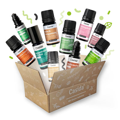 Casida Aroma Club box containing various essential oil bottles with labels and a decorative background.